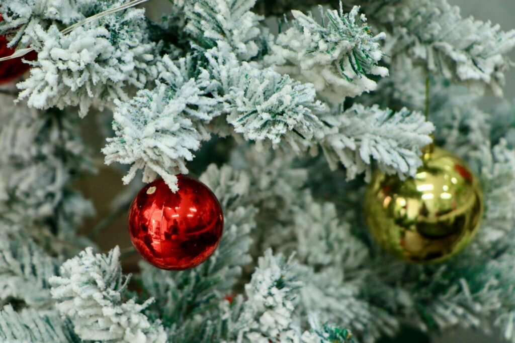 A close up of an artificial flocked christmas tree.